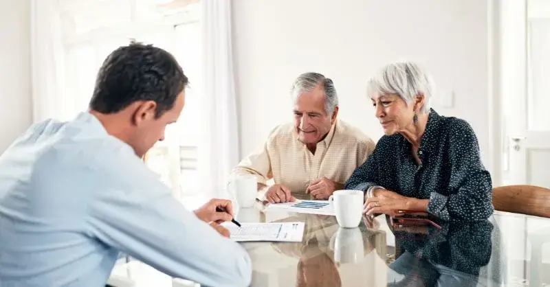 An elderly couple and an advisor