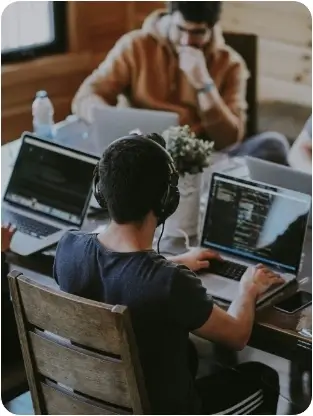 Two people working on desktops