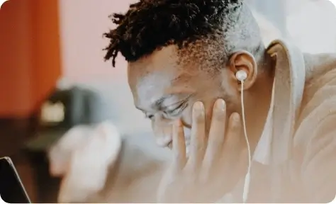 A man with headphones on while using a tablet