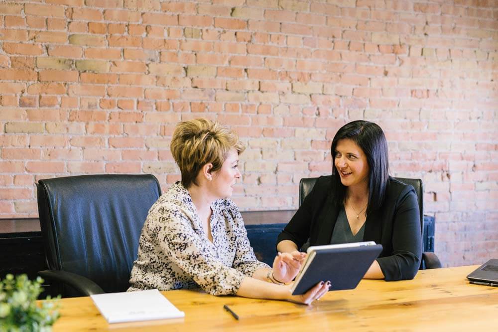 Two professional women in discussion