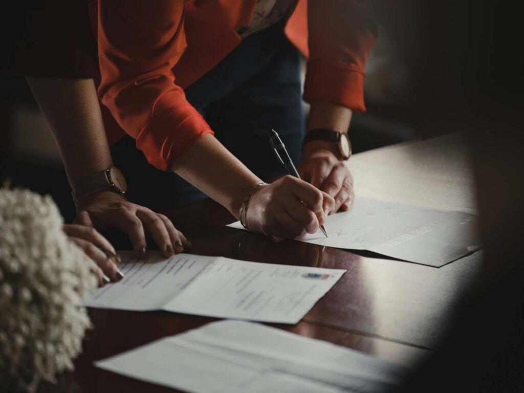 A person with some printouts on a table